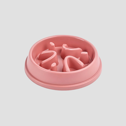 Pink pet feeder with a textured surface on a light gray background